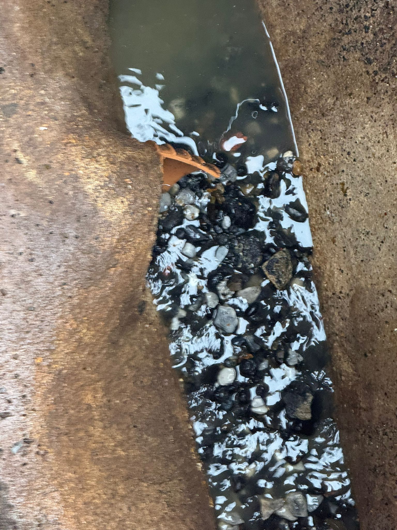 Collapsed drain line with stones